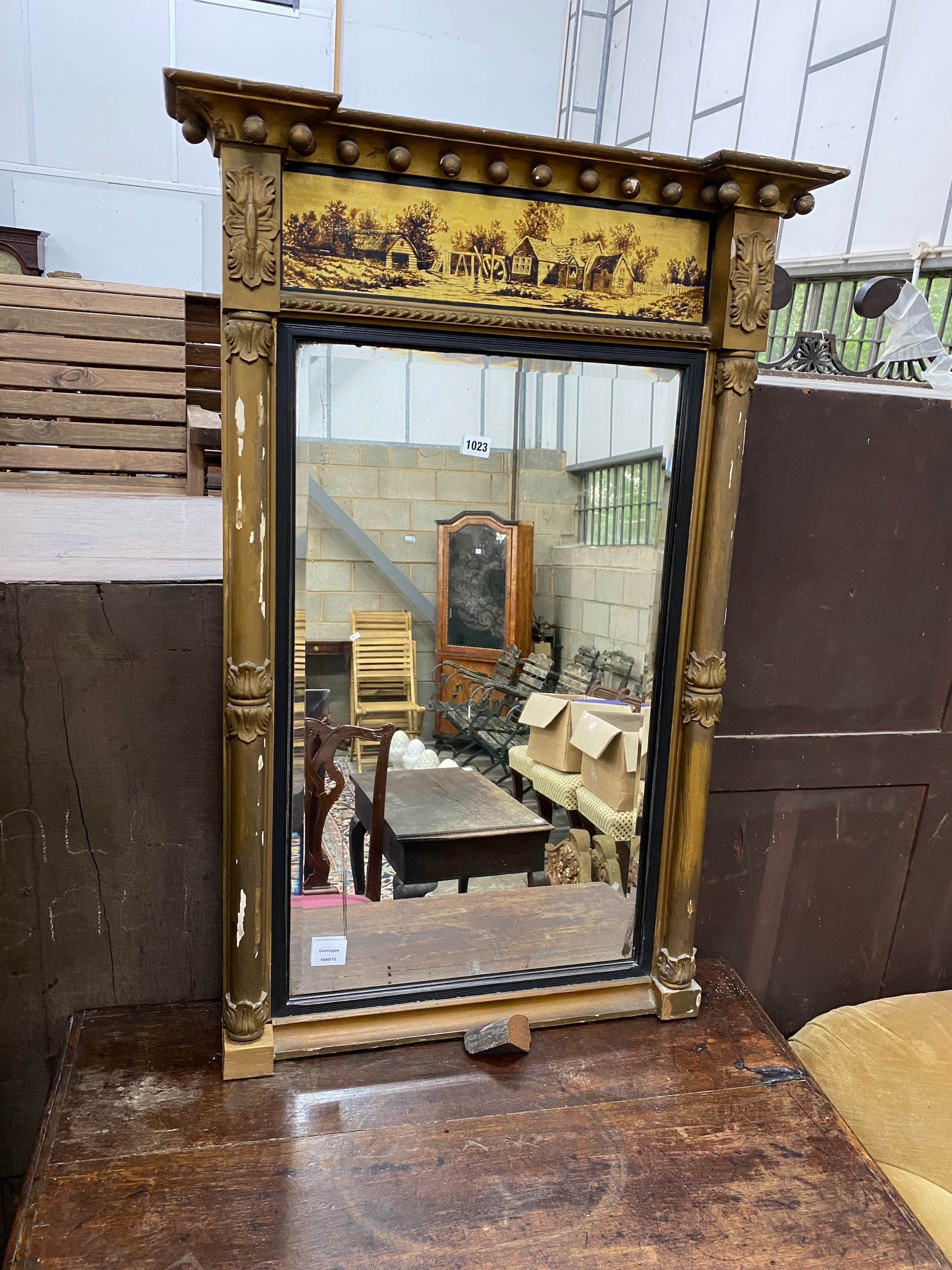 A Regency giltwood pier glass, with a verre eglomise frieze, width 69cm, height 103cm